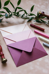 pink mother-of-pearl envelopes on a background of velvet paper