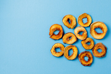slices of dried persimmon on a blue background. dried fruits. eco.