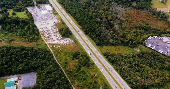 I fly over Interstate I-18 in Greensboro, NC and you can see two cellphone towers alongside the highway, truck and car traffic, and a large car auction lot and truck rental facility.