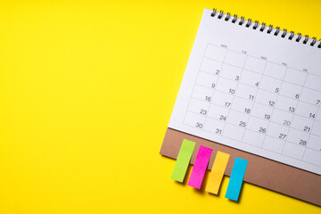 close up of calendar on the yellow table background, planning for business meeting or travel planning concept © tatomm