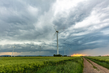 Windräder und Gewitterzelle mit dramatischer Struktur