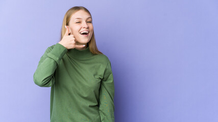 Young blonde woman isolated on purple background showing a mobile phone call gesture with fingers.