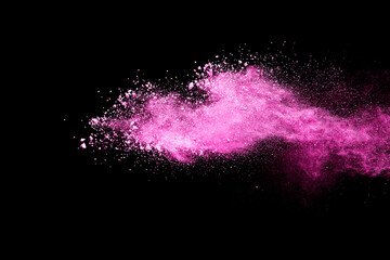 Pink powder explosion on black background. Paint Holi.