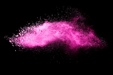 Pink powder explosion on black background. Paint Holi.