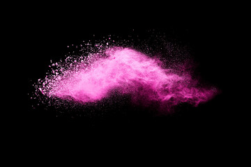 Pink powder explosion on black background. Paint Holi.