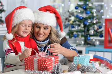 Mature woman and child girl celebrating Christmas