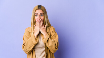 Young blonde caucasian woman shocked covering mouth with hands.