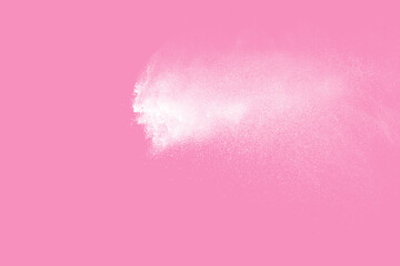 White powder explosion on pink background. Paint Holi.