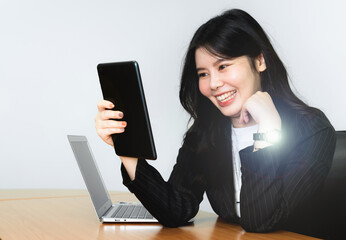 Successful asian senior businesswoman using digital tablet on isolated white background