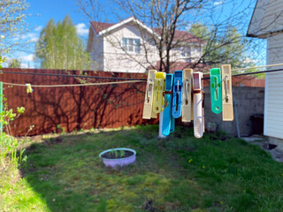 Clothespins hang on a rope in the courtyard of a village house