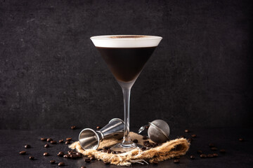 Martini espresso cocktail in glass on black background	