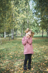 little child three year old girl playing in the park