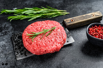 Burger Patty, ground beef meat.  Black background. Top view