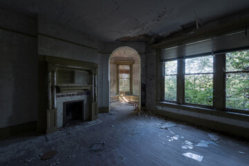 This is an interior view of the corner room with a fireplace and turret at the long-abandoned and historic Dunnington Mansion in Farmville, Virginia.