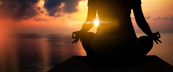The silhouette of woman sitting yoga alone,Relax and meditate,mental health concept with nature...