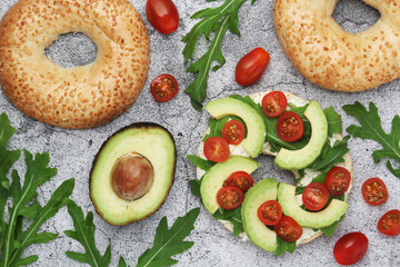 Sesame bagels with tomatoes and avocado
