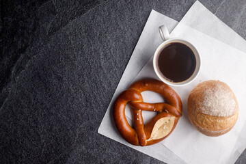 Homemade breads or bun, croissant  bakery ingredients and a cup of coffee on black slate background, breakfast food concept top view and copy space.top view