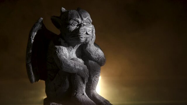 A creepy little gargoyle statuette with eerie fog and a flickering light surrounding it.