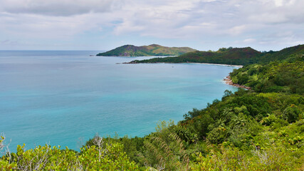 Panoramic view of the northern coast of Praslin island, Seychelles including bay with popular beach Anse Lazio, granite rock formations and tropical rainforest landscape.
