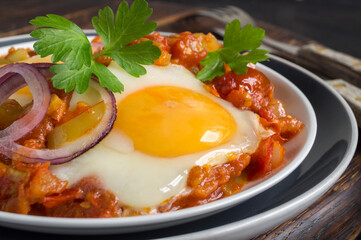 Sunny side up egg with stewed tomatoes.