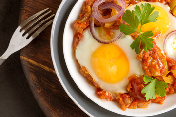 Sunny side up egg with stewed tomatoes.
