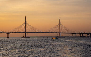 Fototapeta na wymiar Small cable-stayed bridge of the Western high-speed diameter in Saint Petersburg at sunset