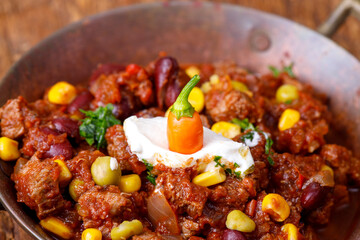 chili con carne on wood