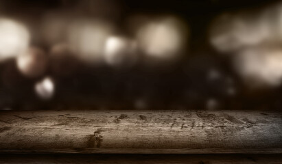 Abstract night scene with wooden table-
Dark abstract night scene with wooden table. Blurred bright bokeh in front of a wooden counter. Background concept for decorations with space for text.