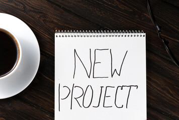 cup coffee and Notebook  on the table.