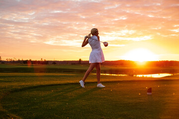 Professional Player Woman Play Golf With Sunset Background .