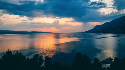 Beautiful sunset reflected in sea water. 16 on 9, Brela Croatia, Makarska riviera