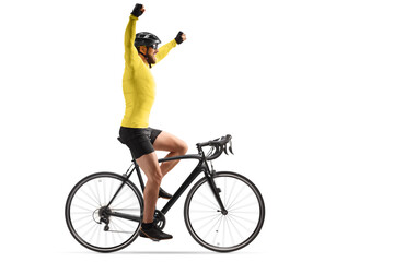 Profile shot of a male cyclist with a helmet riding a road bicycle and spreading his arms