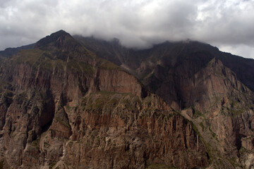 High steep cliff. Landscape with misty mountain peaks and a sheer cliff. Caucasus, Russia. 