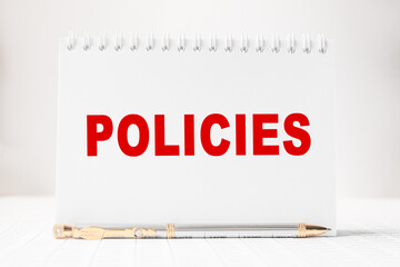Notepad with inscriptions POLICIES on a white background. business concept.
