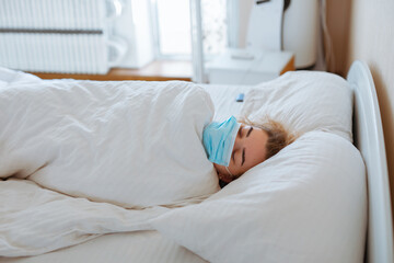 Obraz na płótnie Canvas Woman sleep with surgical mask, coronavirus protection