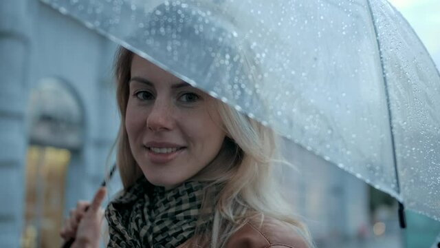 Close-up Portrait Woman under Umbrella at Day Falling Rain in City with Open Smile. Stylish Female Enjoy Fall Drops on Urban Life Background Outdoor. Pretty Eyes Lady in Good Feelings Slow Motion 4k