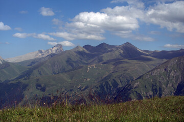 Fototapeta na wymiar Alpine landscape with mountain peaks and green valleys. Caucasus, Russia. 