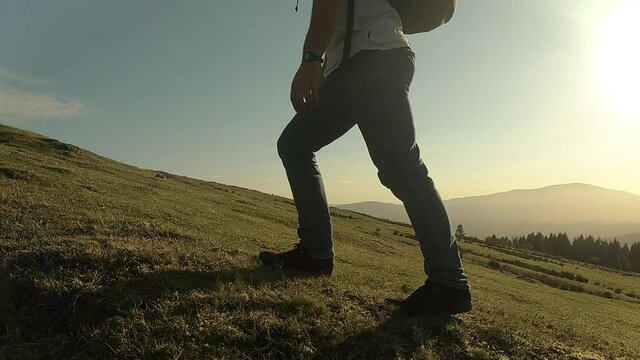 Young boy walking through the bush in the late afternoon