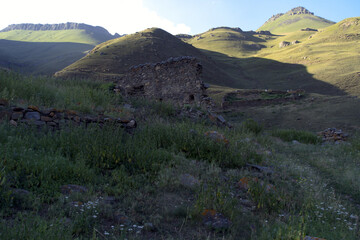 Ruins of an old house in the misty hills. The walls of the old kosh in the mountains. Ruins of the old settlement Shyky. The Balkan poet Kazim Mechiev lived in this village.Caucasus, Russia.