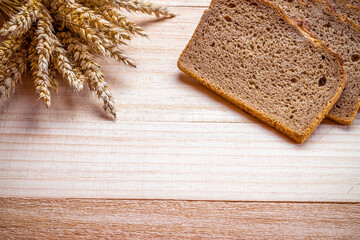 Traditional bread. Fresh loaf of rustic traditional bread with wheat grain ear or spike plant on...
