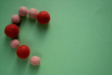 Handmade heart-shaped wool balls for greeting your loved ones.