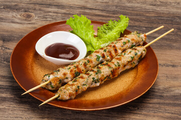 Minced pork skewer kebab with sauce