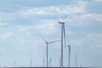 Wind generators farm sustainable industry. Cloudy blue sky cloudscape with Energy turbines power