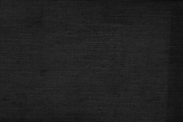 Black natural linen texture as a backdrop. Abstract cotton towel mockup template fabric on the background. Cloth wallpaper of artistic grey wale linen canvas texture for the painting.  