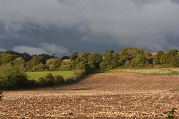Storm clouds over harvested field, autumn in Somerset, England