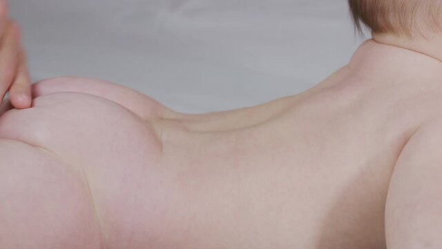 Close view of massaging baby.