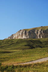 Fototapeta na wymiar stone and grassy landscape. road and mountains