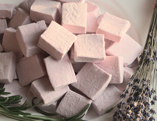 Pink marshmallows, close-up. Aerial jelly dessert. Lavender flowers for tea.