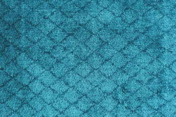 Blue carpet with a diamond pattern. Scuff marks on the new carpet.

