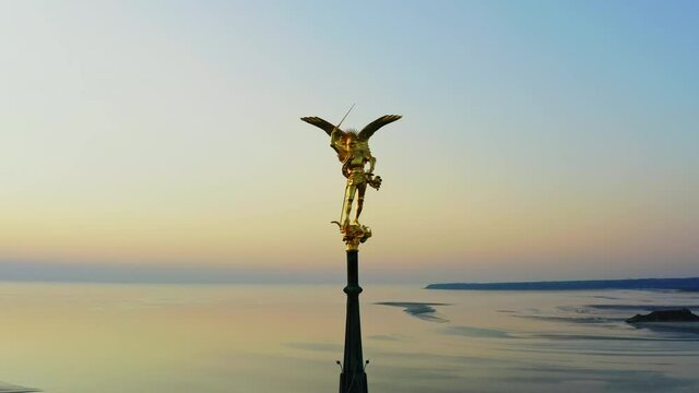 Aerial view of Archangel Michael statue on top of the Mont Saint Michel cathedral France